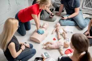 CPR demonstration on a dummy by an instructor.